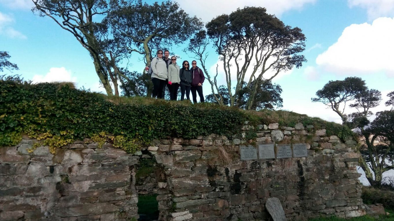 Vagabond tours guests standing on Dunboy Castle ruins