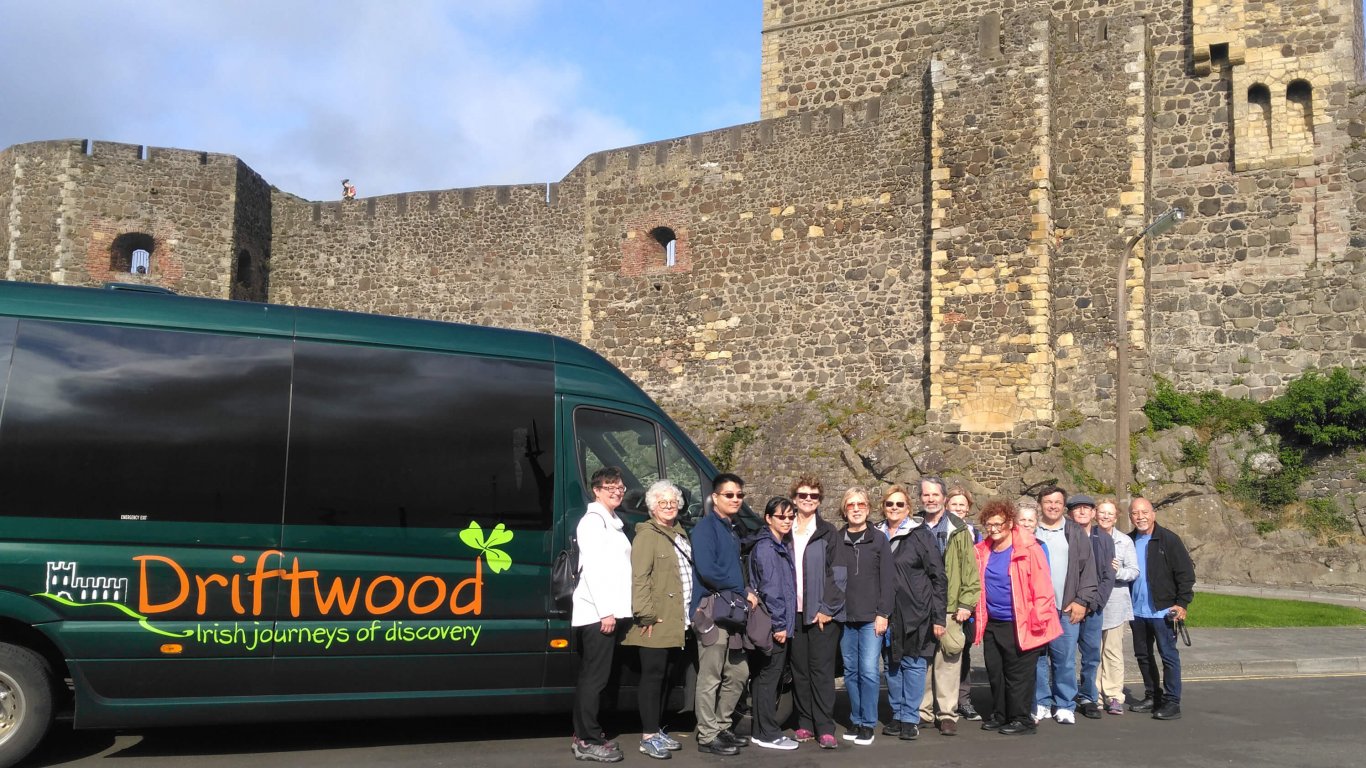 Group at Castle with Driftwood Tour Vehicle in Ireland
