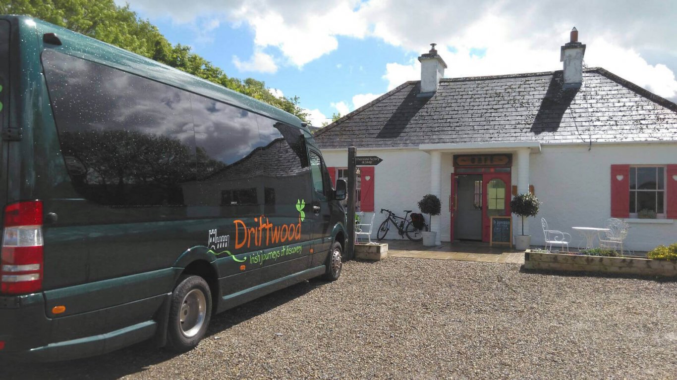 Driftwood Drifter tour vehicle parked outside cottage in Ireland