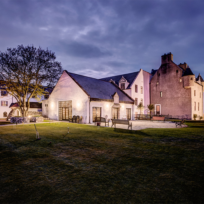 An exterior view of ballygally castle in dusk