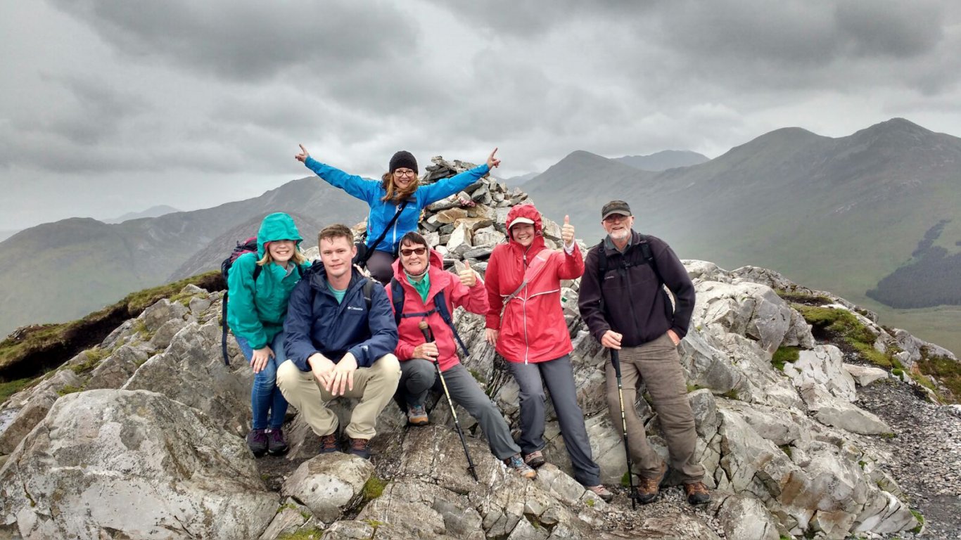 Hiking group on the summit of Diamond Hill in Connemara National Park, Ireland