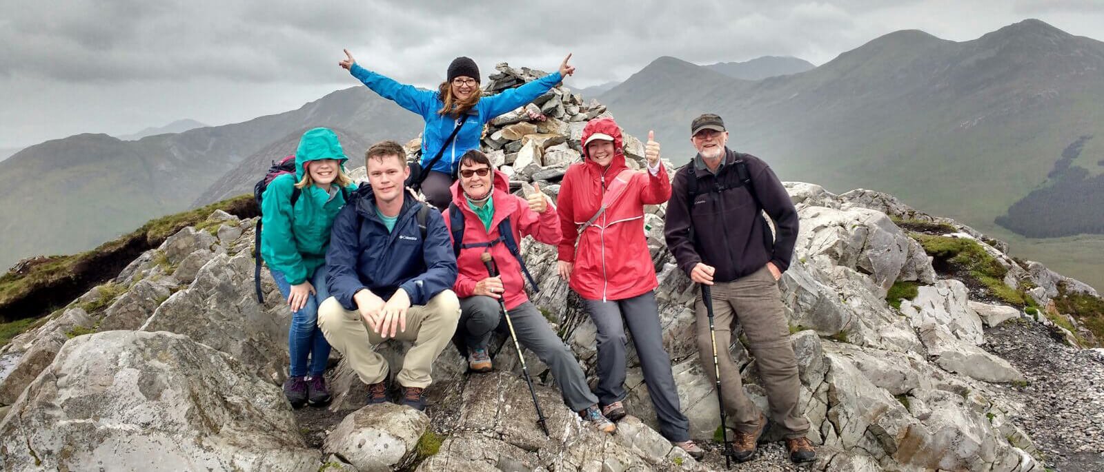 Group of Vagabond tour guests looking satisfied at the summit of Diamond Hill in Connemara