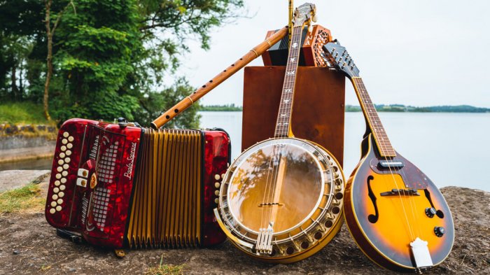 Three traditional Irish musical instruments including an accordion, a banjo and a bazouki