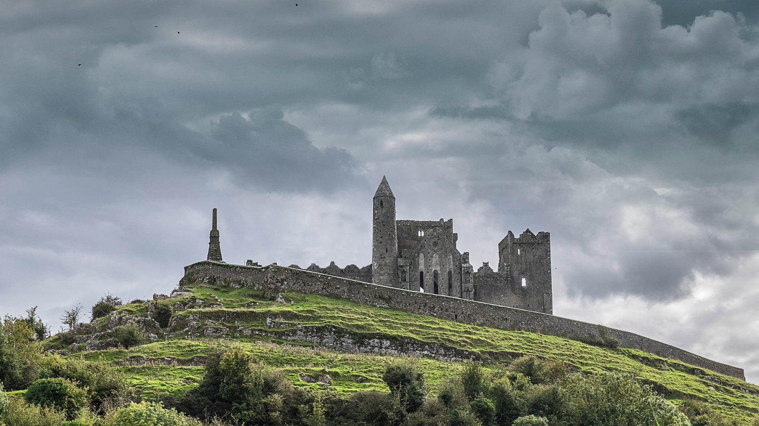 The monumental Rock of Cashel rises above the green Tipperary landscape