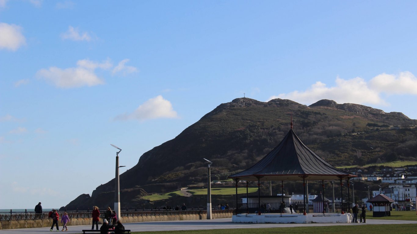 A bandstand on Bray seafront with a view of Bray Head in the distance 
