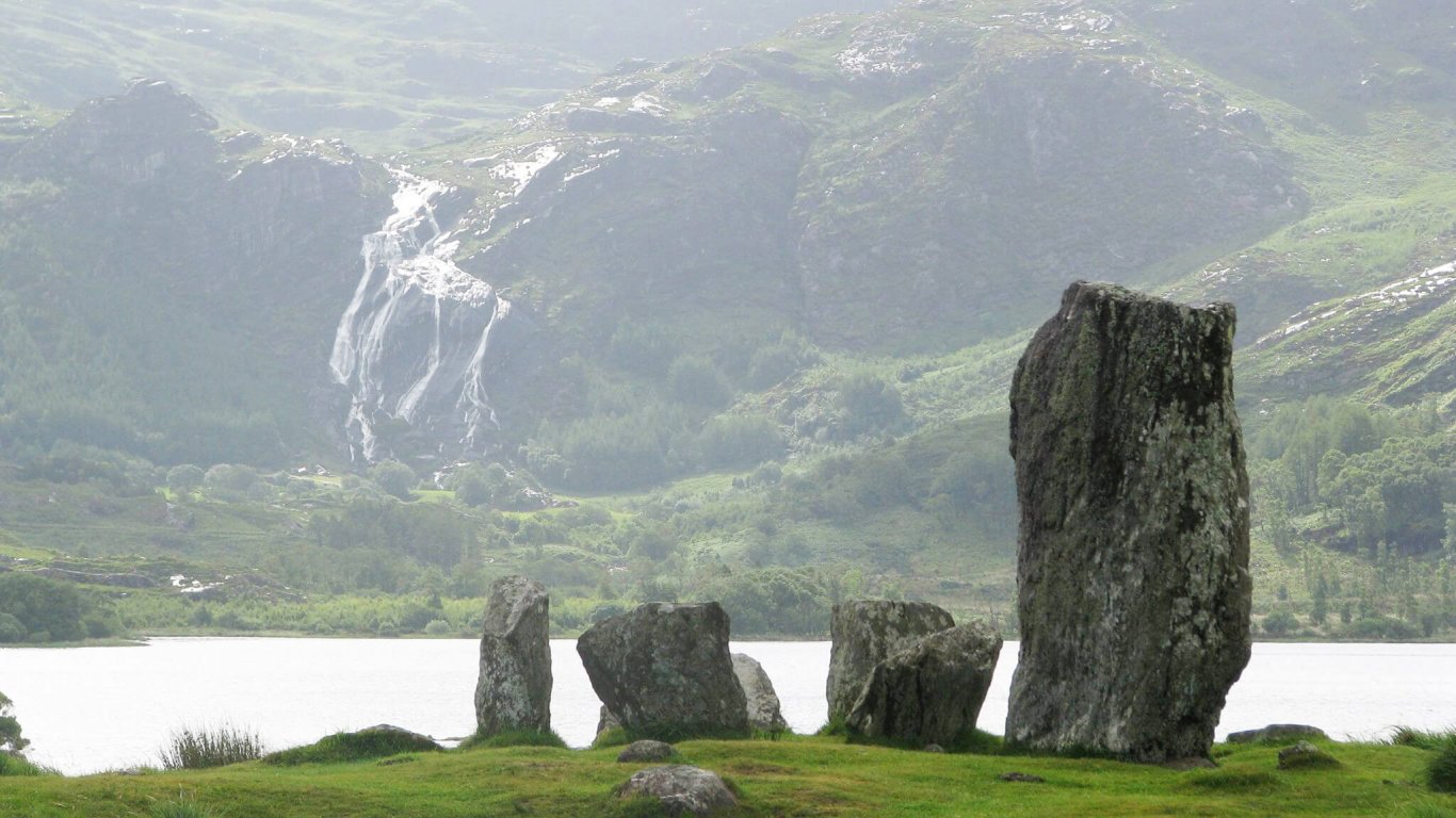 Uragh Stone Circle with lake and waterfall in the Gleninchaquin Valley, Ireland