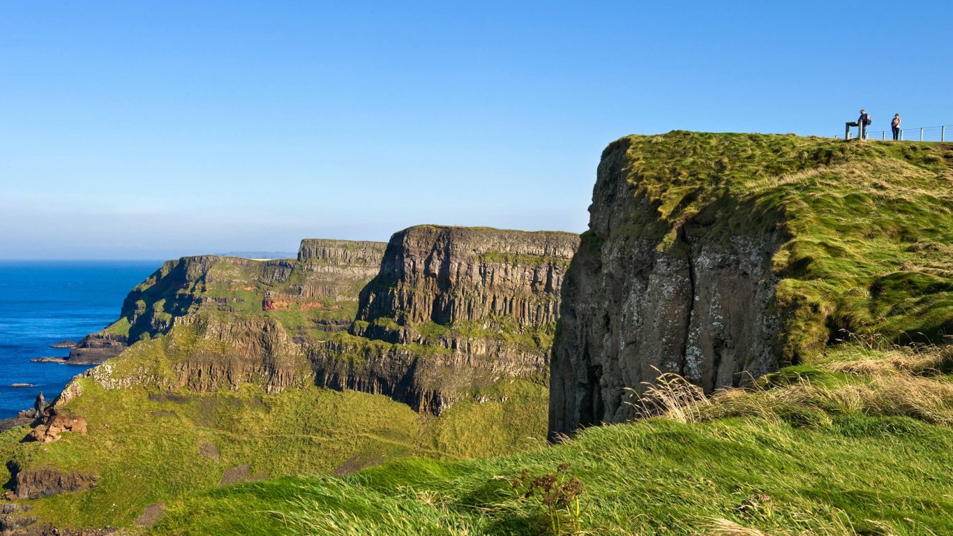 Hikers on the dramatic Antrim Causeway Coast in Northern Ireland