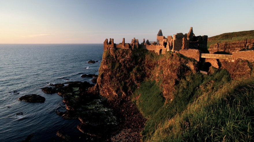 Sunset strikes the ruins of Dunluce Castle in Northern Ireland