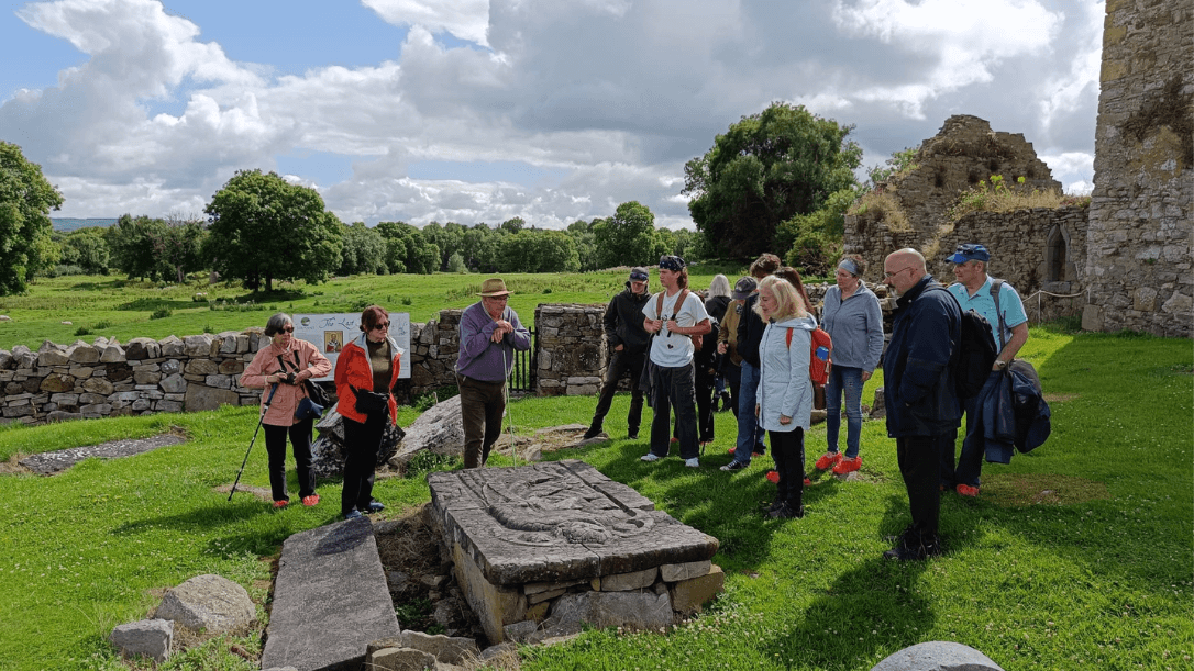 A group of guests in Jerpoint park getting a tour