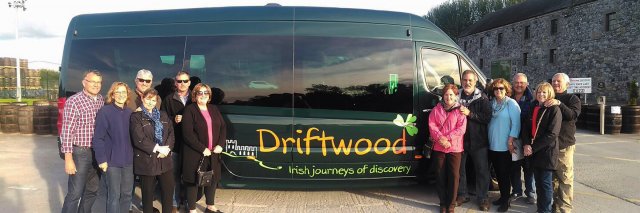 Driftwood guests posing in front of a Driftwood bus