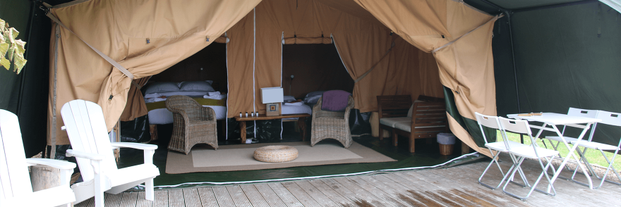 The exterior and interior of a Glamping tent on a Vagabond tour
