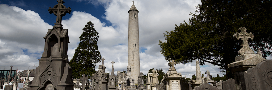 The graves in Glasnevin Cemetery with the round tower in the distance