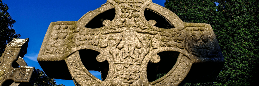 A high cross with visible markings and designs
