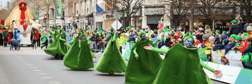 Parade performers taking part in the Dublin St. Patrick's Day parade in front of crowds
