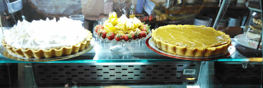 Three dessert tarts on display in a cake shop