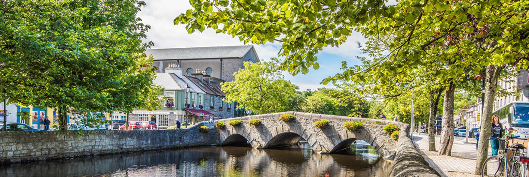 Westport Town on a sunny day with trees and a river in view 