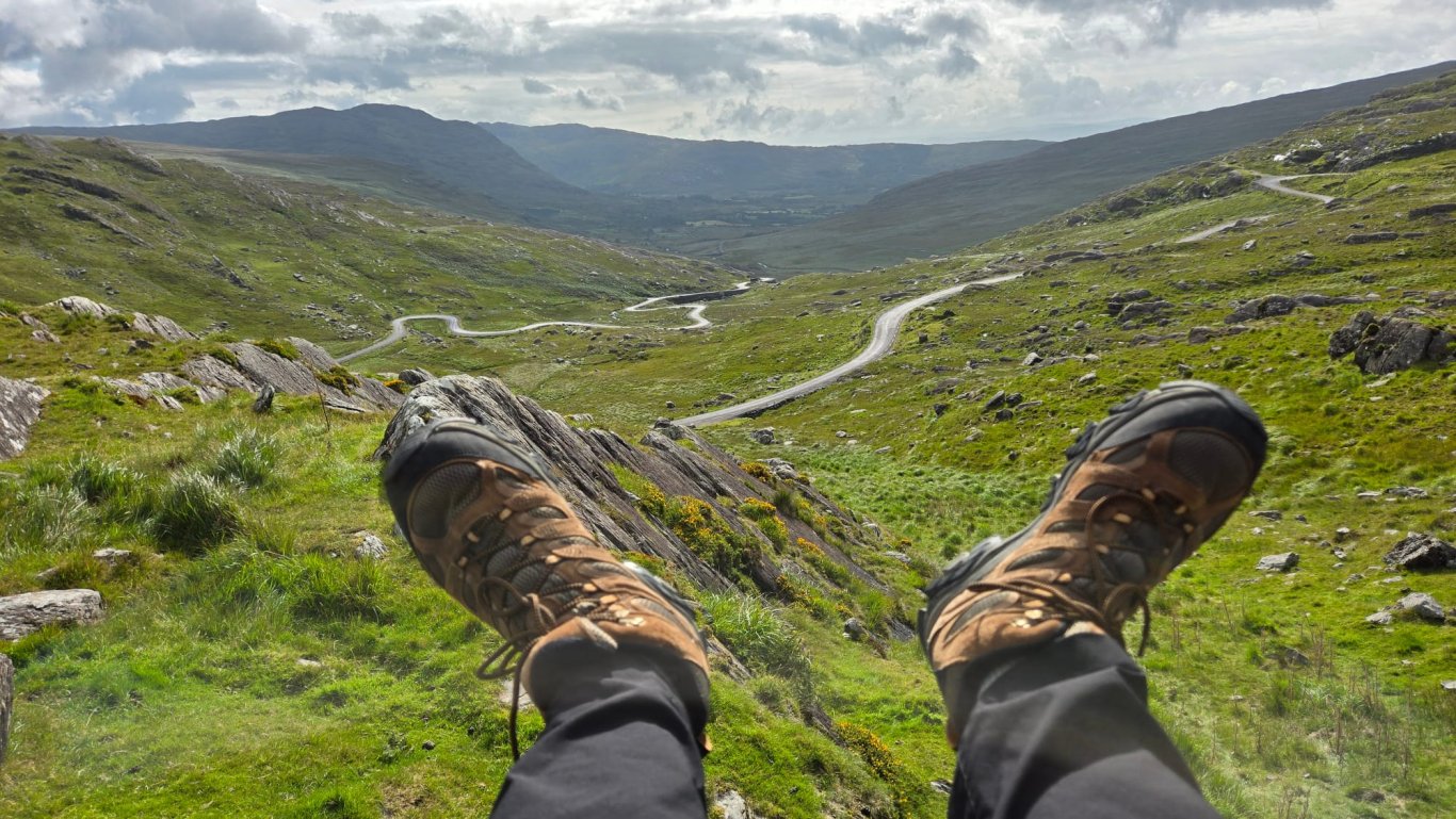Guide's hiking boots sitting down on the healy pass