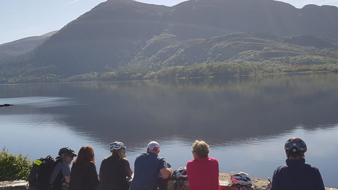 Tour group looking at a scenic lake in Killarney National Park in Ireland