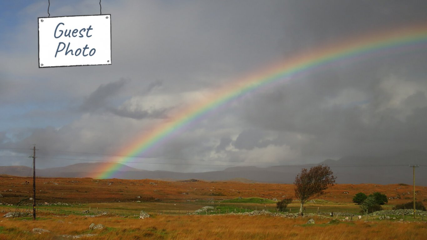 Rainbow over scenic landscape in Ireland