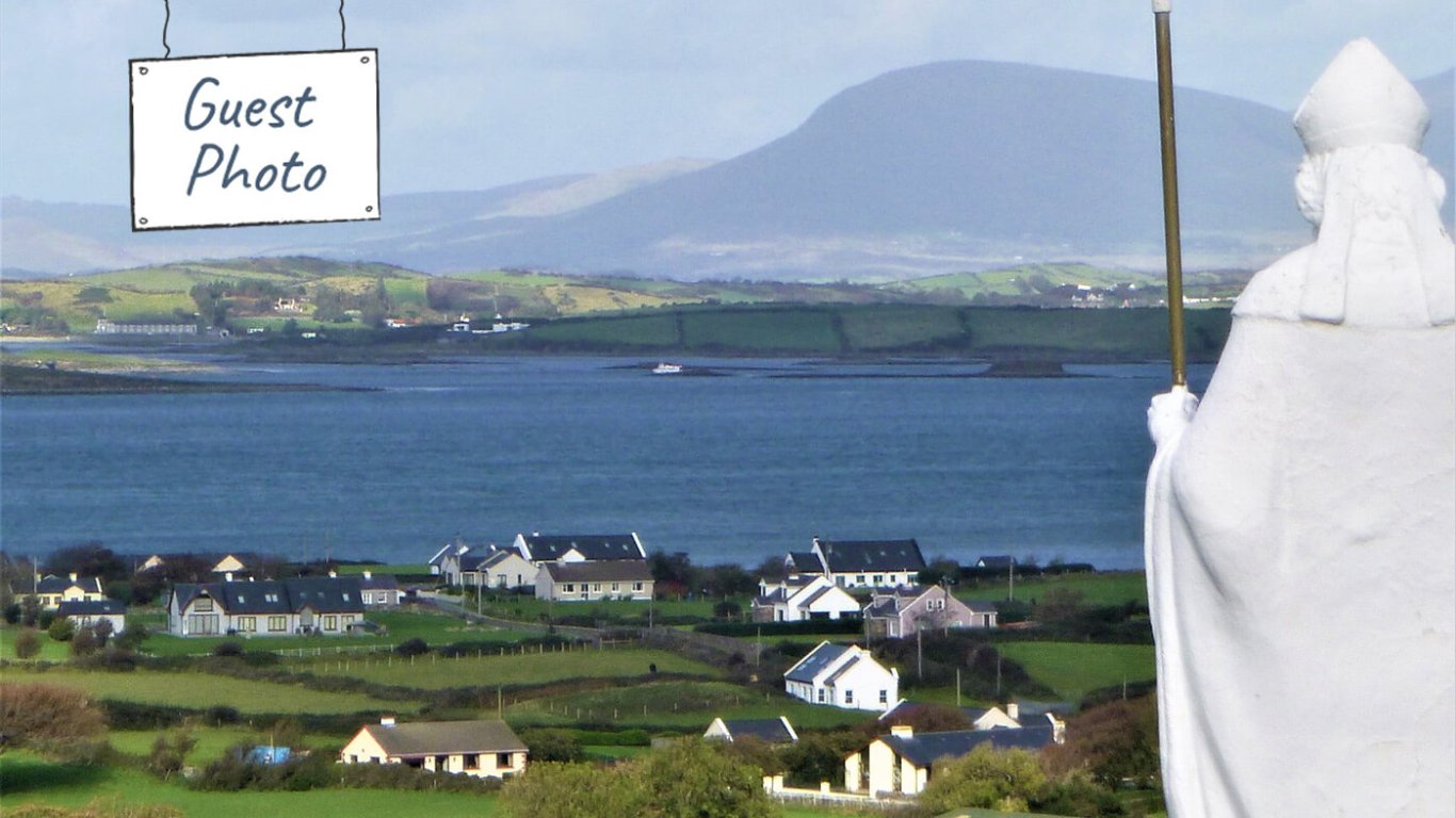 Vagabond Tours guest photo of Saint Patrick statue and Clew Bay in Mayo, Ireland