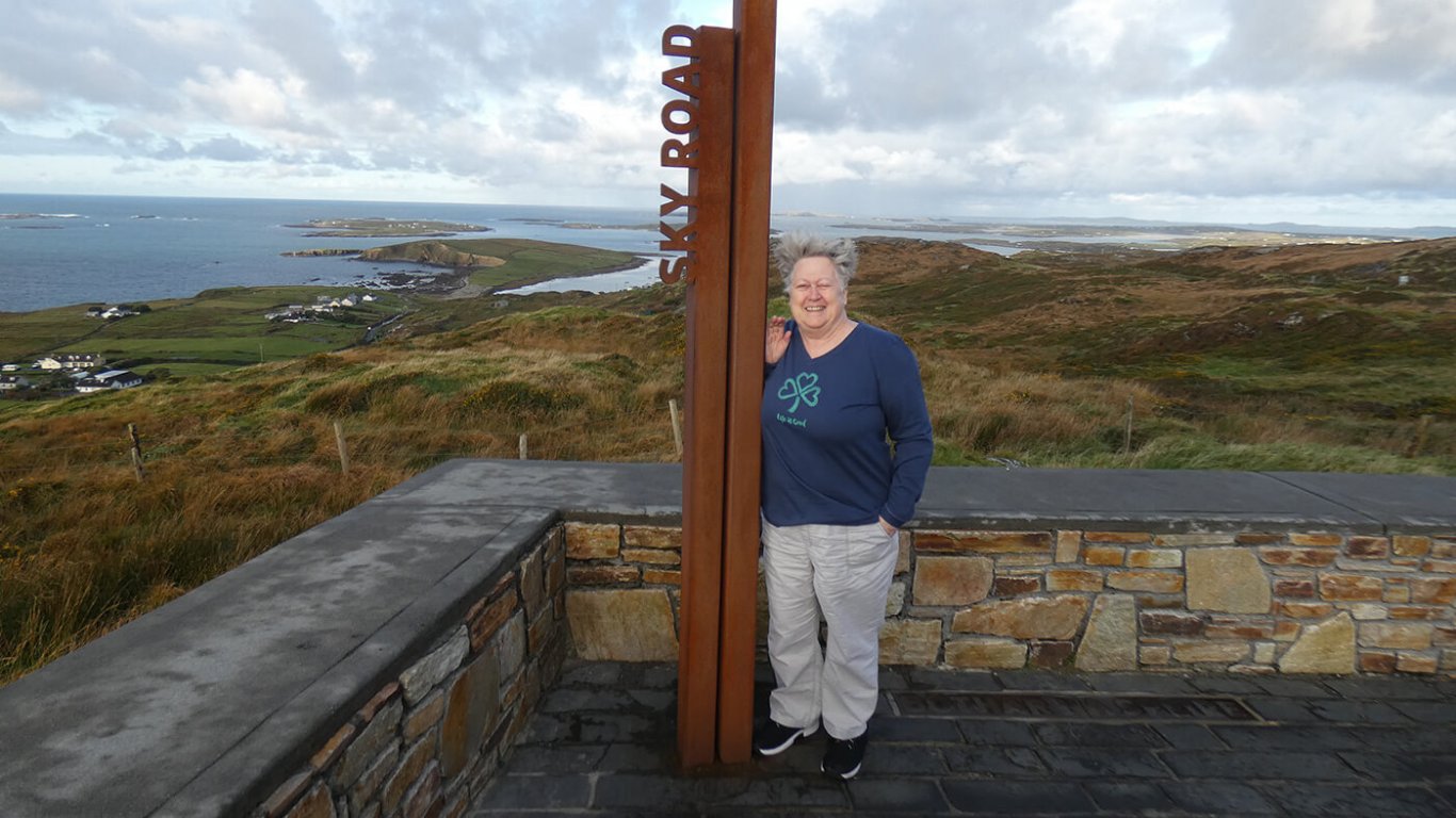 Guest standing at Sky Road Wild Atlantic Way Sign near Clifden in Connemara, Ireland