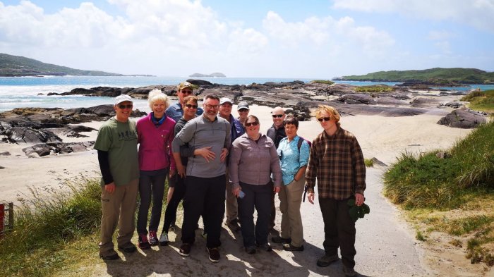 A happy tour group on a beach in Ireland