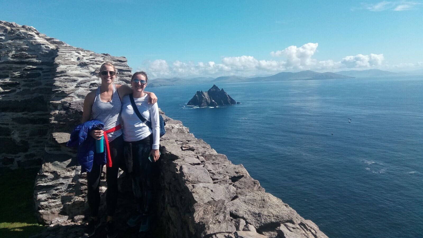 Two tour guests standing at the summit Skellig Michael island in Ireland