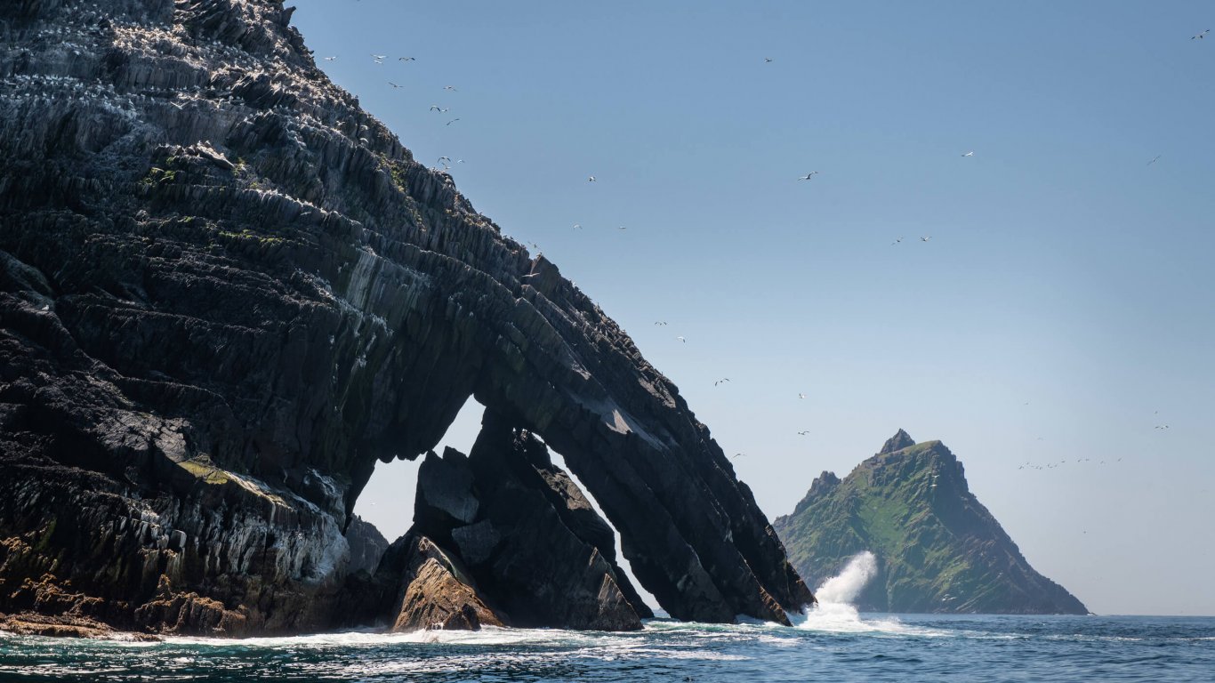 Sea arch on Little Skellig Island showing seabirds and Skellig Michael in the background