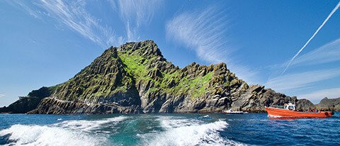 Little Skellig Island with red boat in Ireland