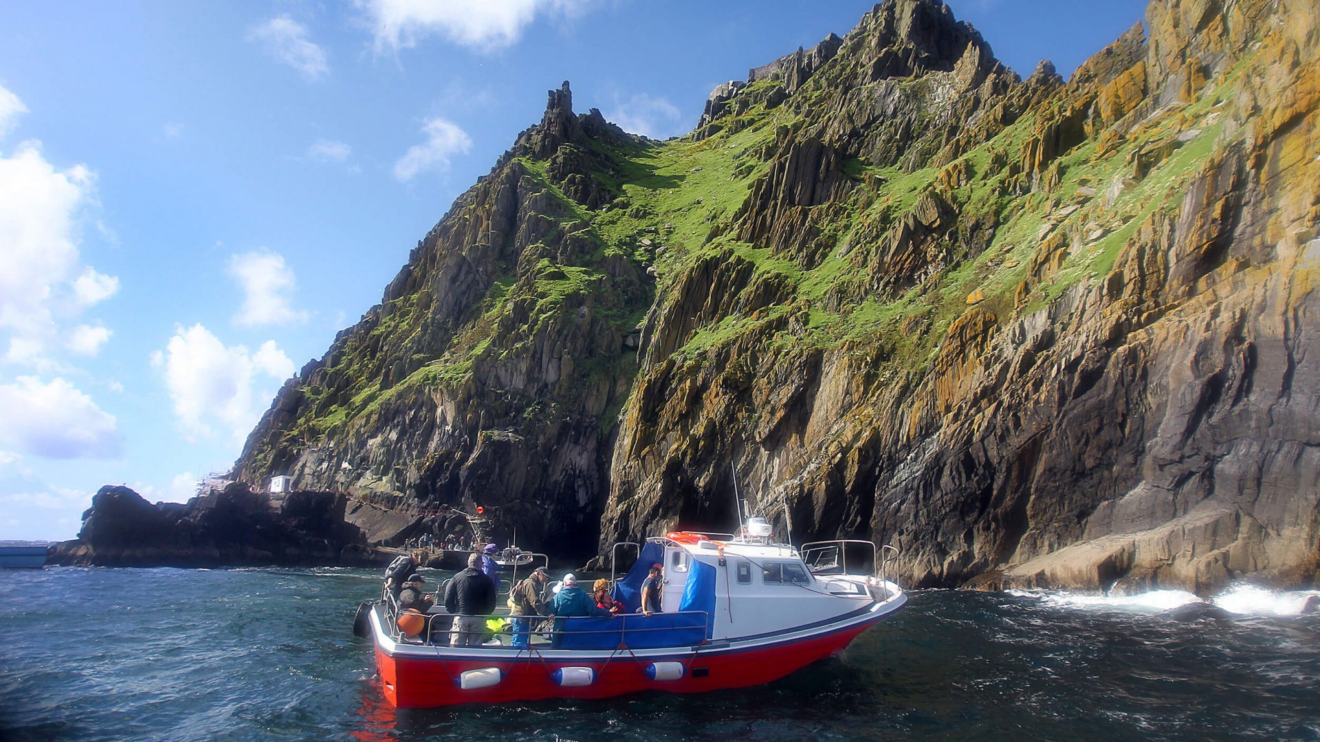 Boat in the sea with tour guests aboard off Skellig Michael Island in Ireland