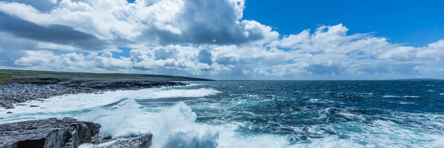 Waves and blue sky with clouds in Clare, Ireland