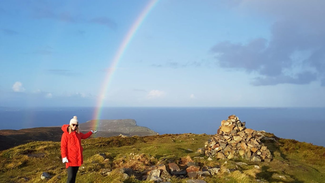 Guest pretending to catch the end of the rainbow for gold