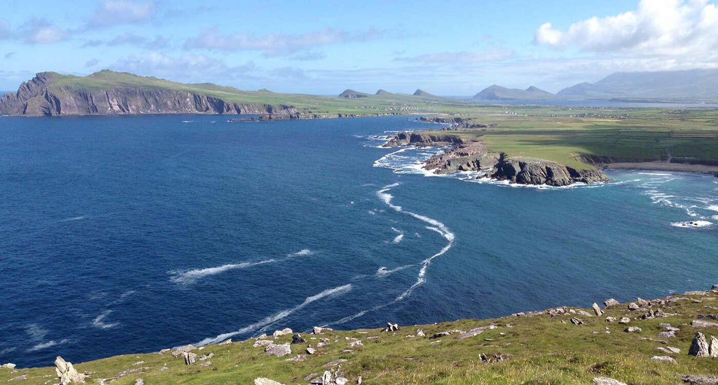 A view of Slea Head on the Dingle peninsula and a view of the three sisters mountains in the distance