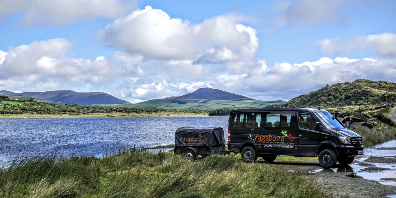 A Vagabond Tours VagaTron 4x4 tour vehicle and trailer parked up at Lough Annascaul