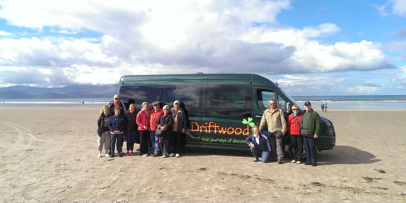 Tour group with vehicle on beach in Ireland