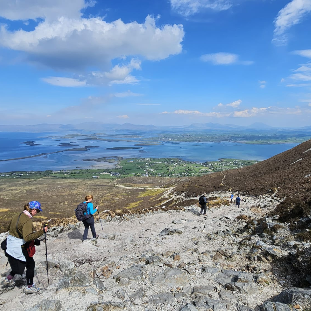 A vagabond group hiking back down croagh patrick