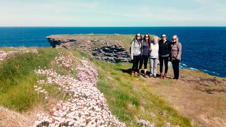 Tour group in scenic coastal location in Ireland
