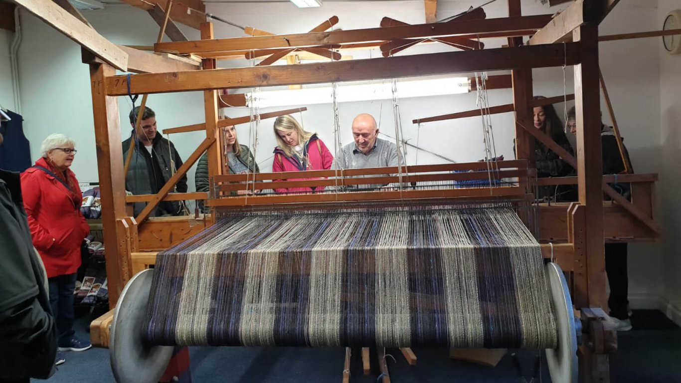 Vagabond tour guests visit Eddie Doherty's weaving studio in Ardara, Donegal