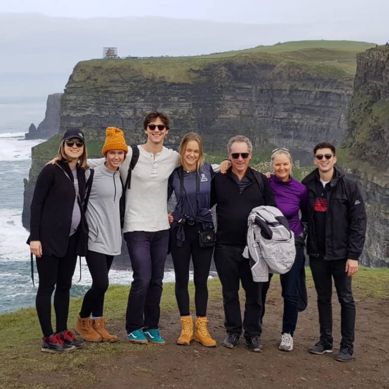 Family group posing at the Cliffs of Moher