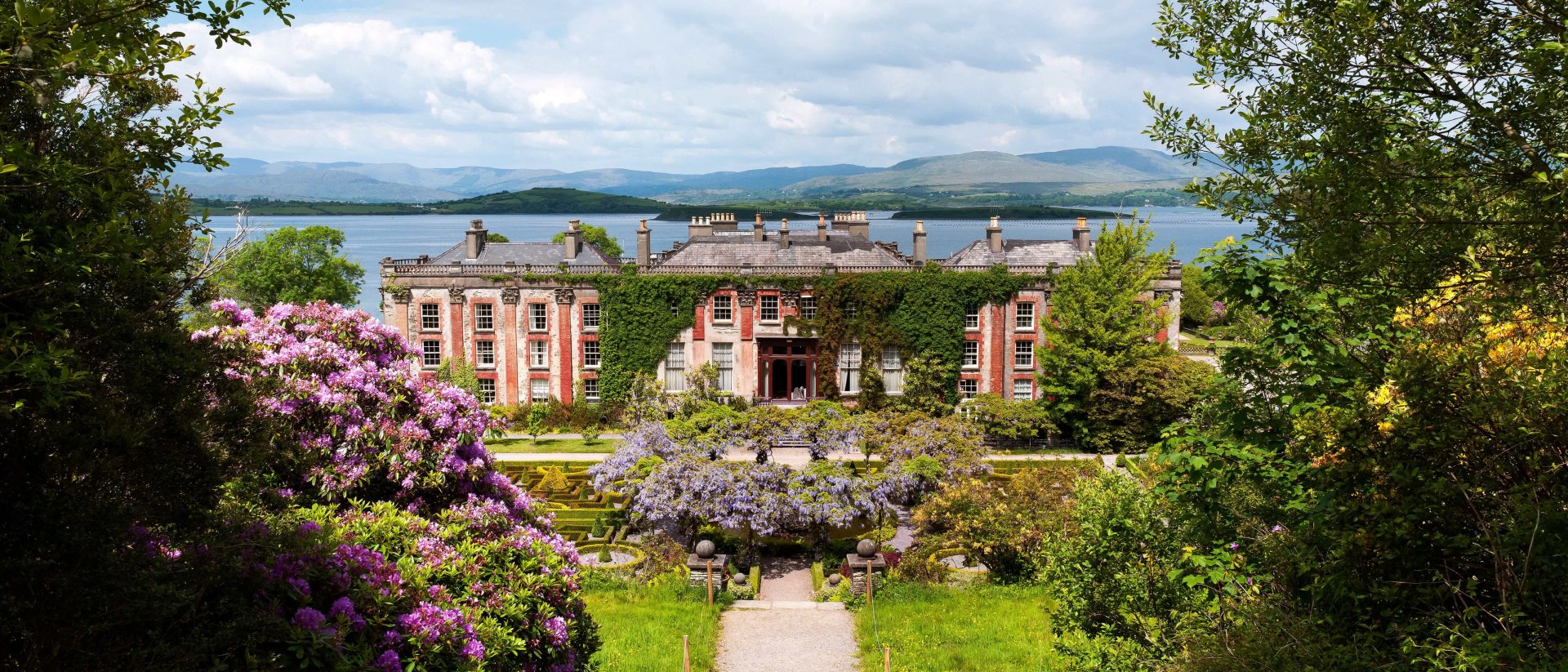 Bantry House Gardens in Ireland with scenic mountain and sea view in the background
