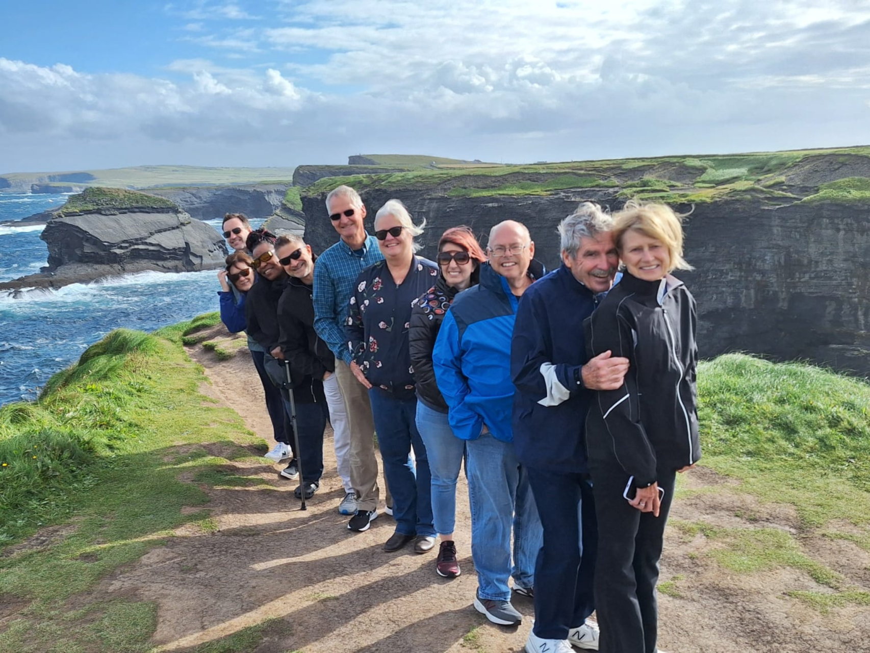 A group of guests taking a group photo on kilkee cliffs