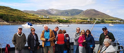Happy tour group on a boat trip during their Northern Ireland tour in October 2022
