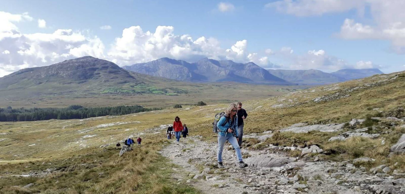 Hikers in a scenic landscape in Connemara, Ireland