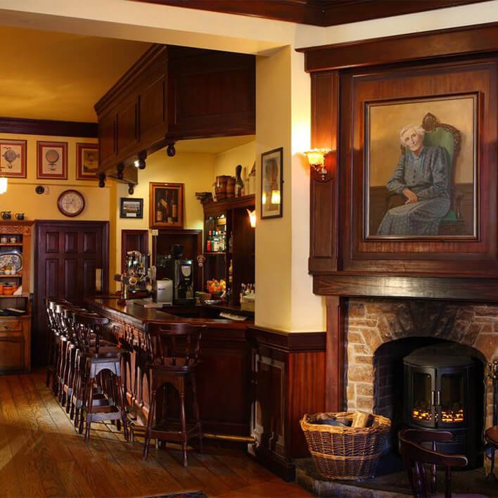 The traditional Irish interior of the Dingle Benners bar and Restaurant with a lighting fire 