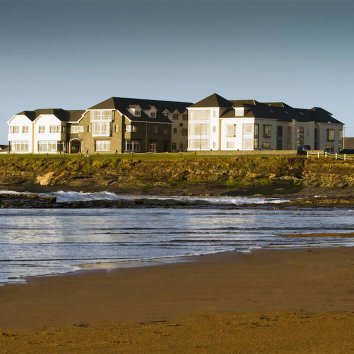The exterior view of the Armada Hotel located on the Atlantic coastline with a beach at its front door