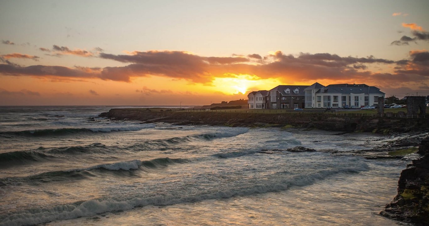 Spanish Point beach at sunset with Armada Hotel in Ireland