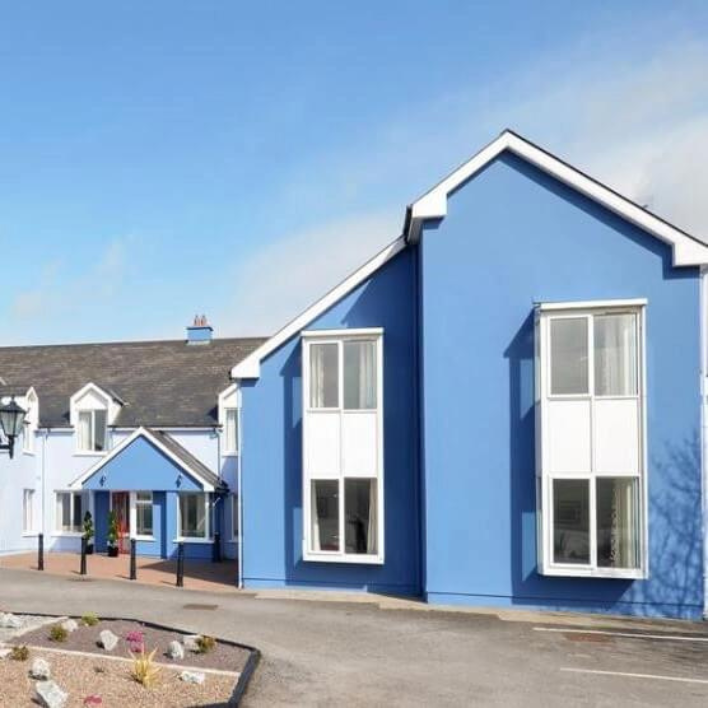 The exterior of Dingle Harbour Lodge painted in blue and white