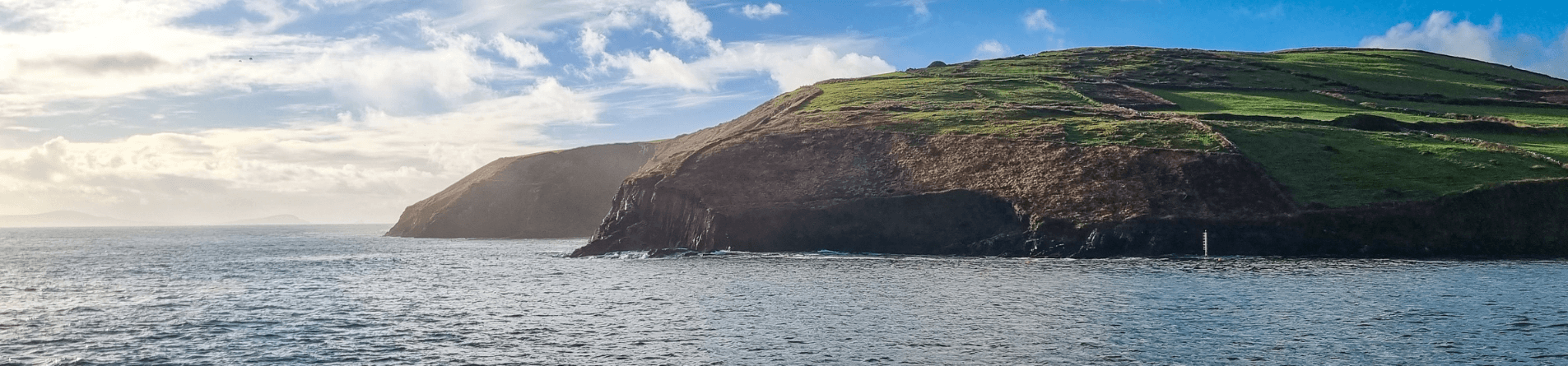 Green cliffs on the edge of dingle bay