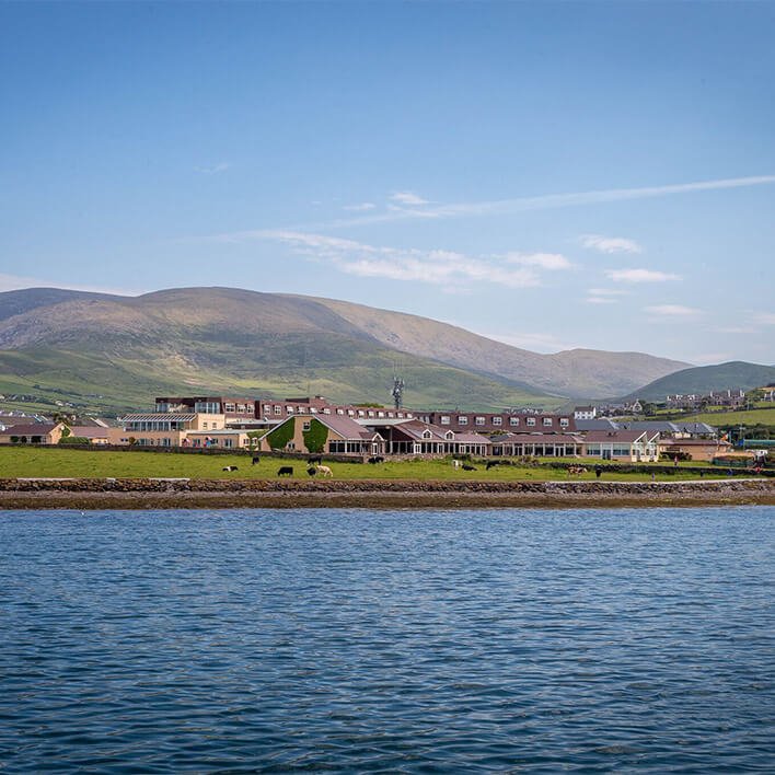 An amazing view of the Dingle Skellig Hotel and Dingle Bay with mountains in the background