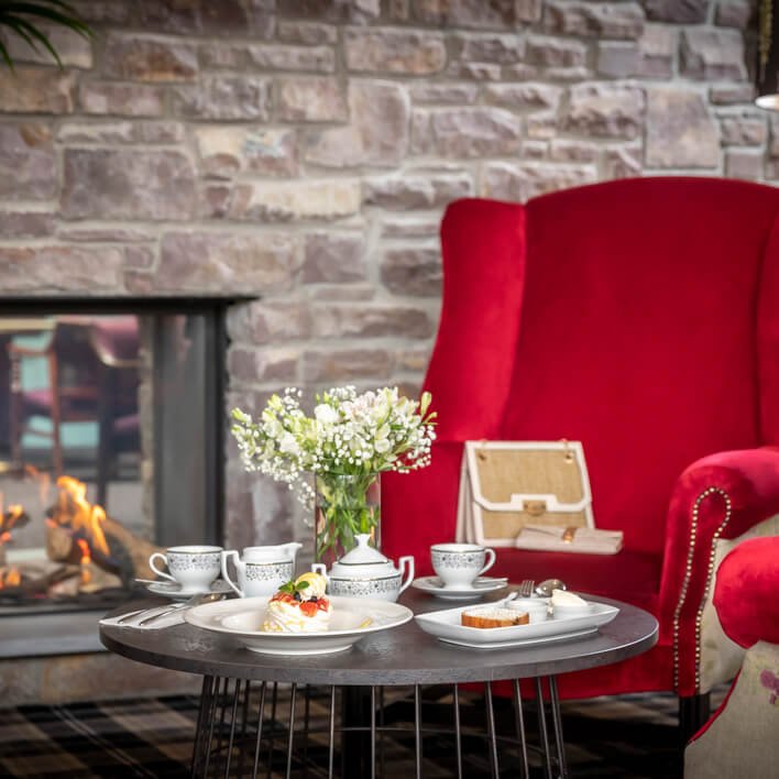 Red armchair and tea on table at Dingle Skellig Hotel in Ireland